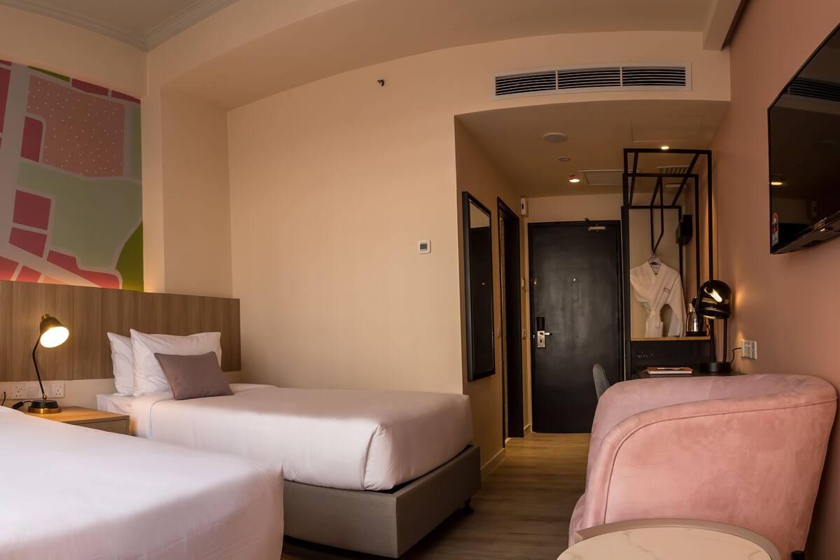 A hotel room with two beds, a large abstract wall art, a TV, and a mirror.