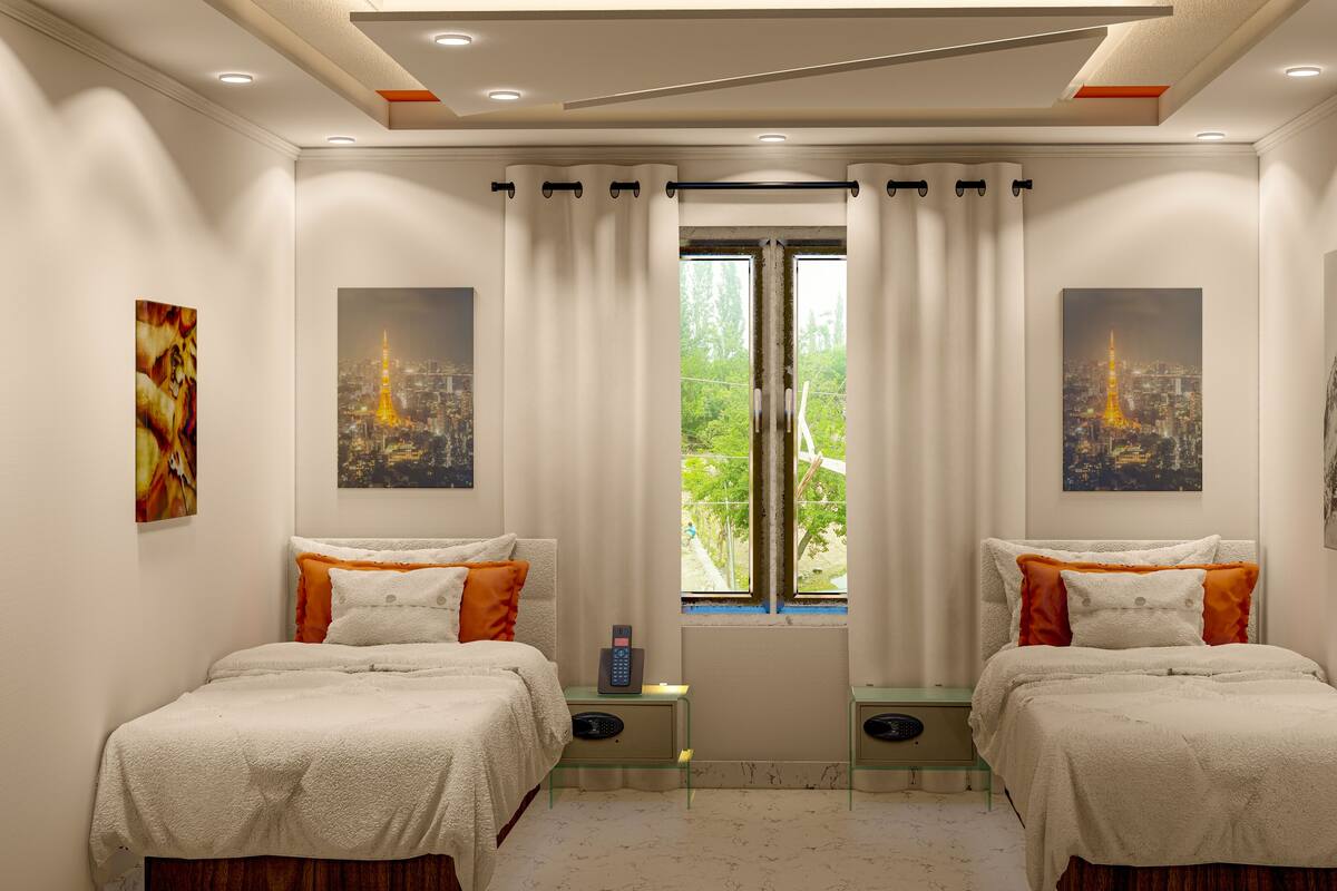 A hotel room with two beds, a window with curtains, and artwork on the walls.