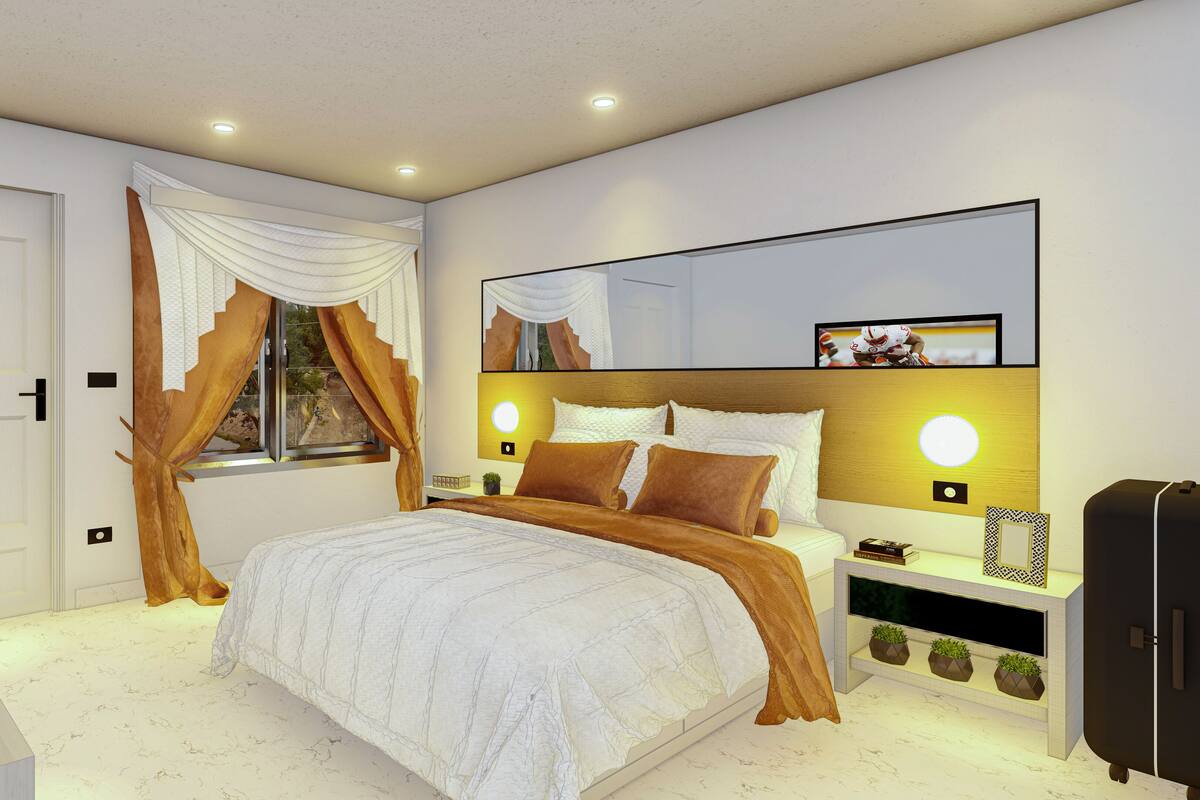 A modern bedroom with a large bed, a bedside table, a nightstand, a mirror, and a wardrobe.