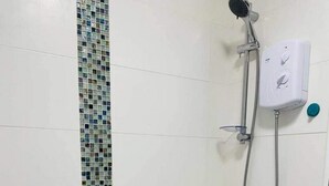A bathroom with a white bathtub, a shower with a handheld showerhead, and a wall-mounted control panel. - 2 Bed Self Contained Apartment Wrexham (Wrexham)