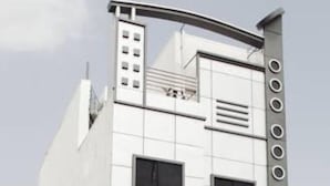 A modern hotel building with a grid of windows and a distinctive vertical design element on the facade. - Hotel Durga Silverline (Jodhpur)
