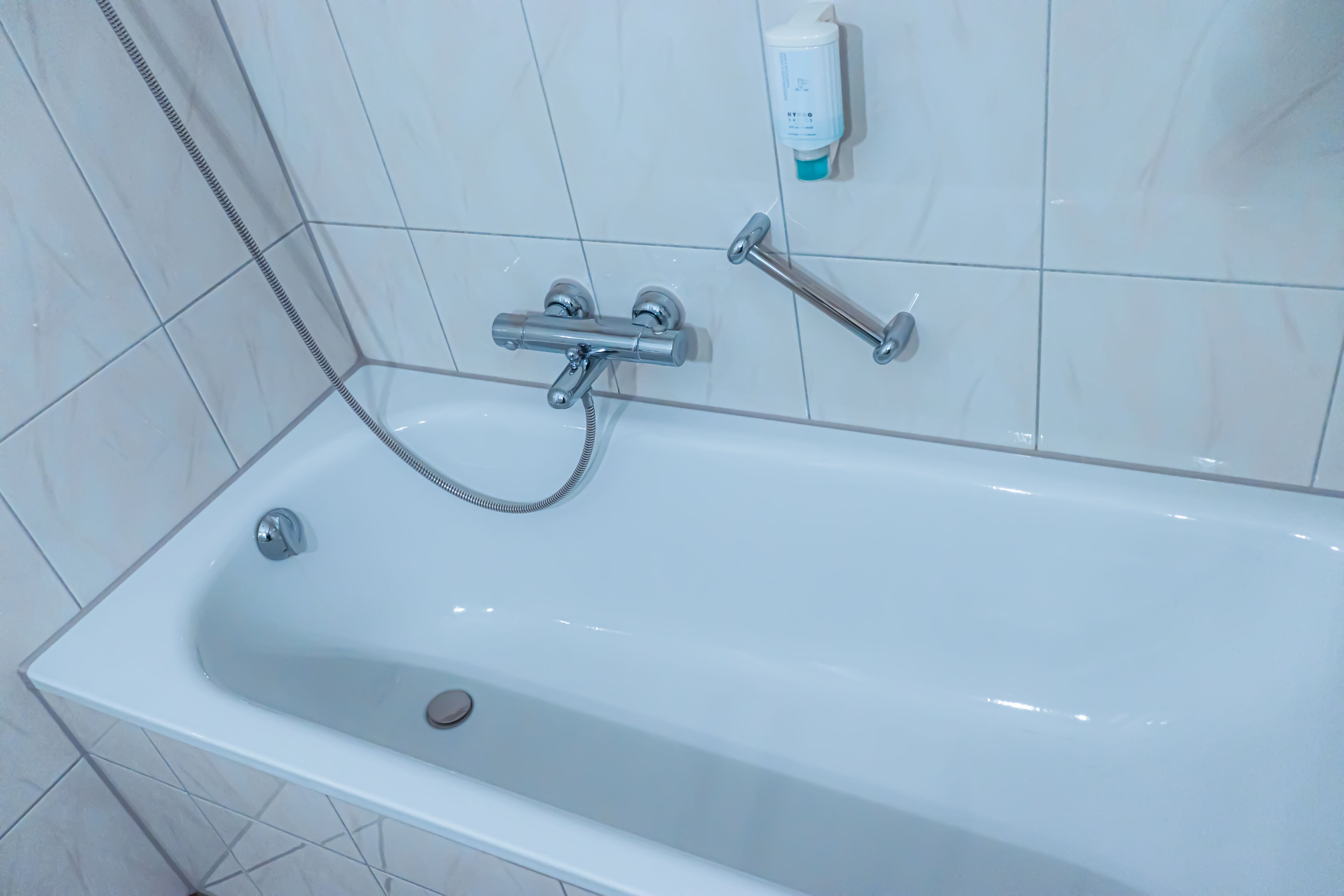 separate bathtub and shower, hair dryer, towels, soap