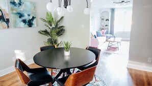 A dining area with a round table, chairs, and a potted plant. - Charming 2BR Getaway | Pets Welcome in Cloverdale (Montgomery)