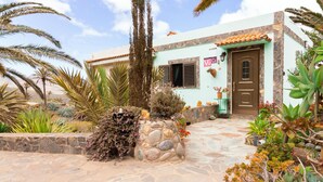 A building with a stone facade, a tiled roof, and a stone pathway leading to the entrance. - Stunning home in Vallehermoso with WiFi (Vallehermoso)