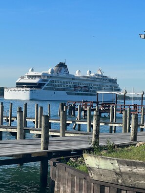Docked at the pier, this cruise ship offers stunning views from its upper deck.