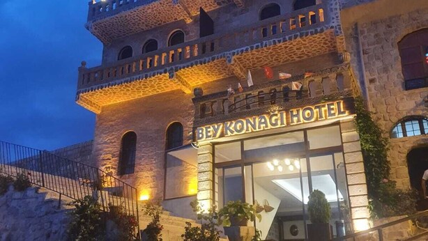 A historic hotel with a stone facade, a balcony with railings, and a sign reading "BEY KONAGI HOTEL".