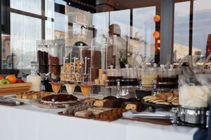 A buffet with various food items and beverages.