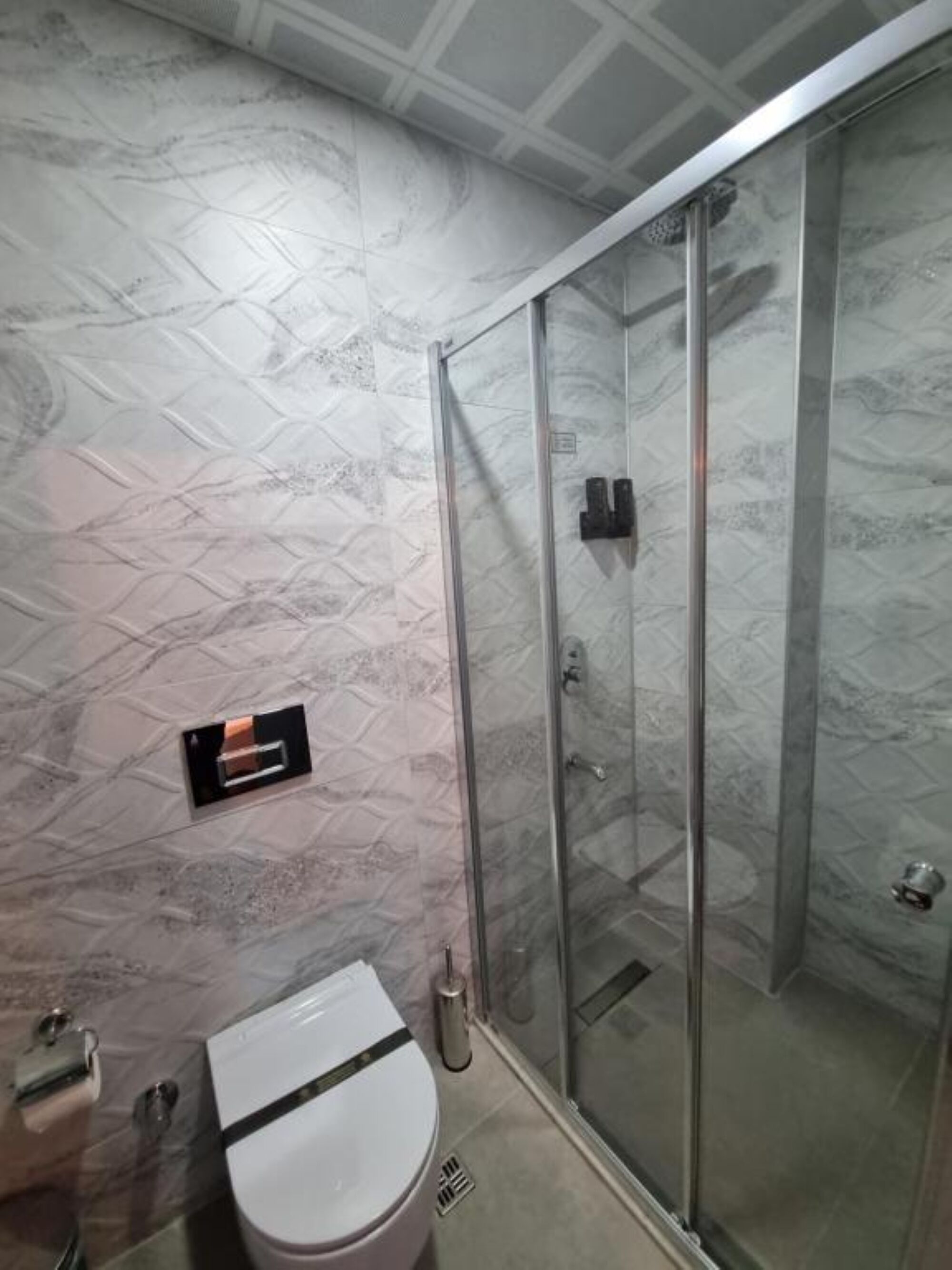 premium room, city view | bathroom | shower, rainfall showerhead, hair dryer, slippers