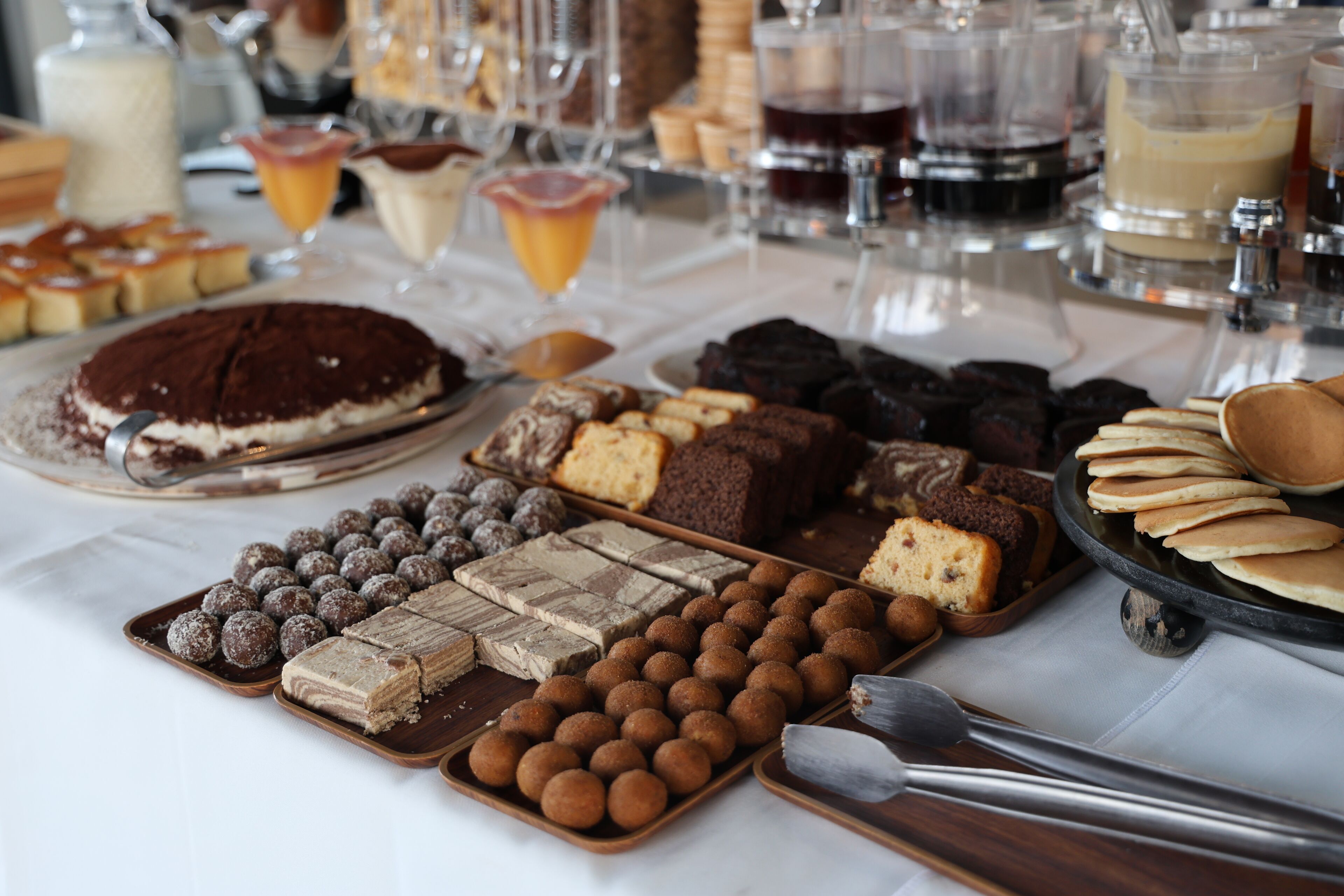 A variety of desserts and beverages on a table.