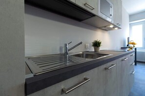 Kühlschrank, Mikrowelle, Herdplatte, Wasserkocher mit Kaffee-/Teezubehör