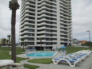 Enjoy a poolside retreat with lounge chairs and umbrellas.