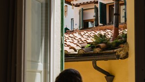 Vista a través de una ventana, con una persona apoyada en el marco.