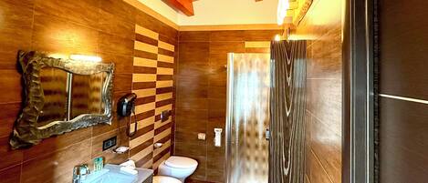 A modern bathroom with a wooden ceiling, a large mirror, a sink, a toilet, and a shower area.
