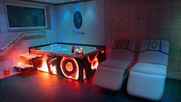 Relax in a heated bath with a clear view, surrounded by plush lounge chairs and ambient lighting.