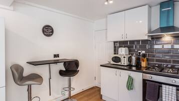 Fridge, oven, coffee/tea maker, cookware/dishes/utensils