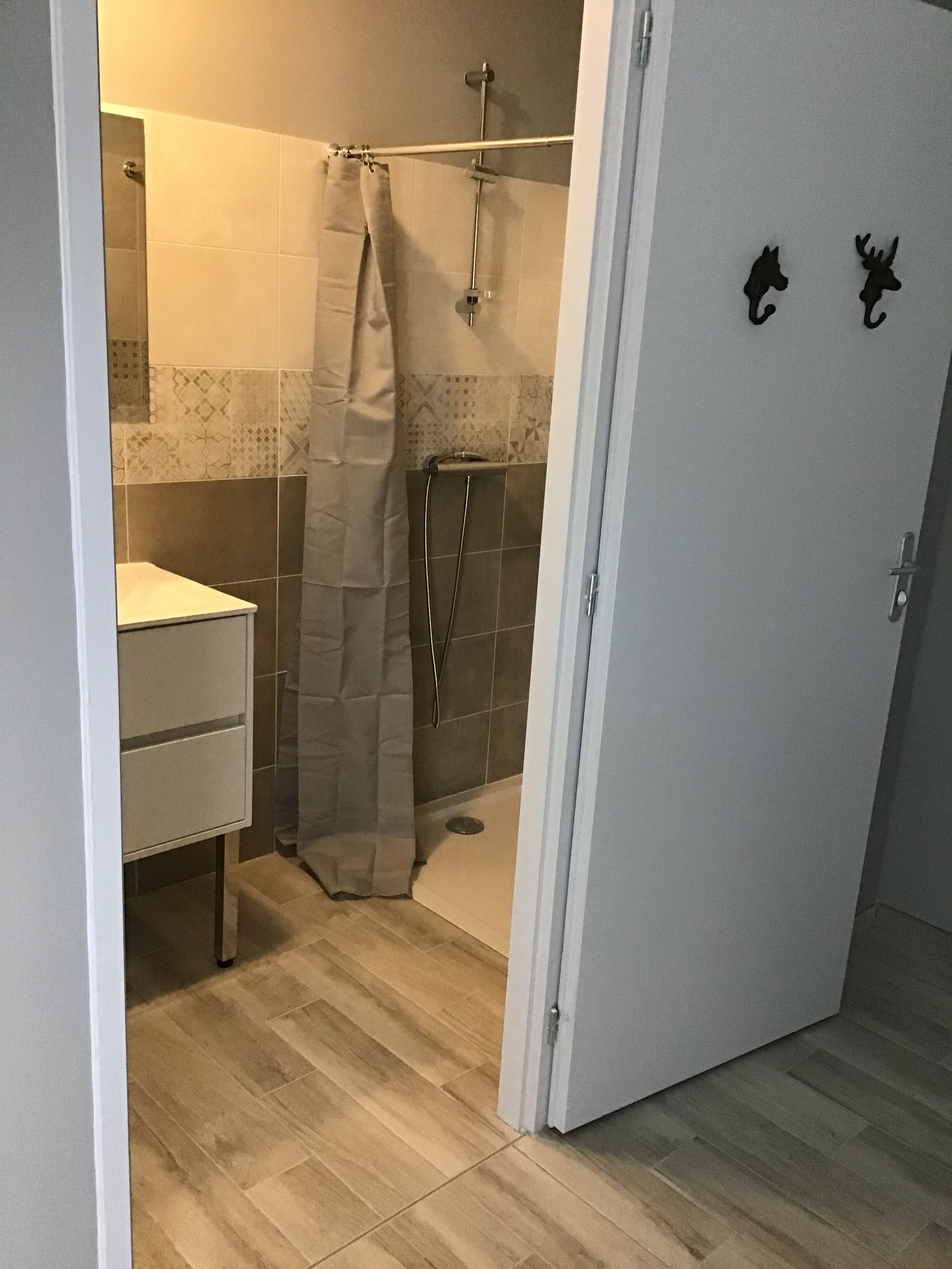 A bathroom with a shower, a toilet, and a sink.