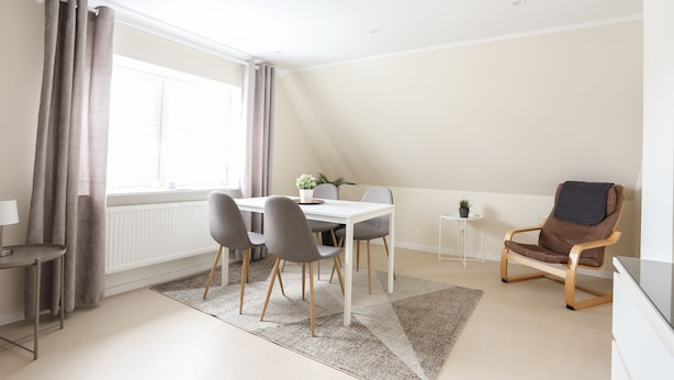 A dining area with a table, chairs, and a TV stand. - Beautiful vacation apartment in Kassel (Kassel)