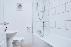 Combined shower/tub, hair dryer, towels, toilet paper