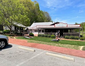 A building with a sign that reads "Cascade Hollow Distilling Co." and "U.S. Post Office" on the front. - Bueller's Barrel House - Your Exquisite Getaway (Golf Cart Included) (Tullahoma)