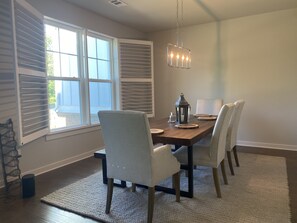 Enjoy meals in this inviting dining area with a beautifully set table and comfortable seating for four.
