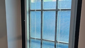 A door with a window, a white frame, and a metal latch. - Hibiscus Suite - Private Studio Apartment in Rhinebeck Village (RHINEBECK)