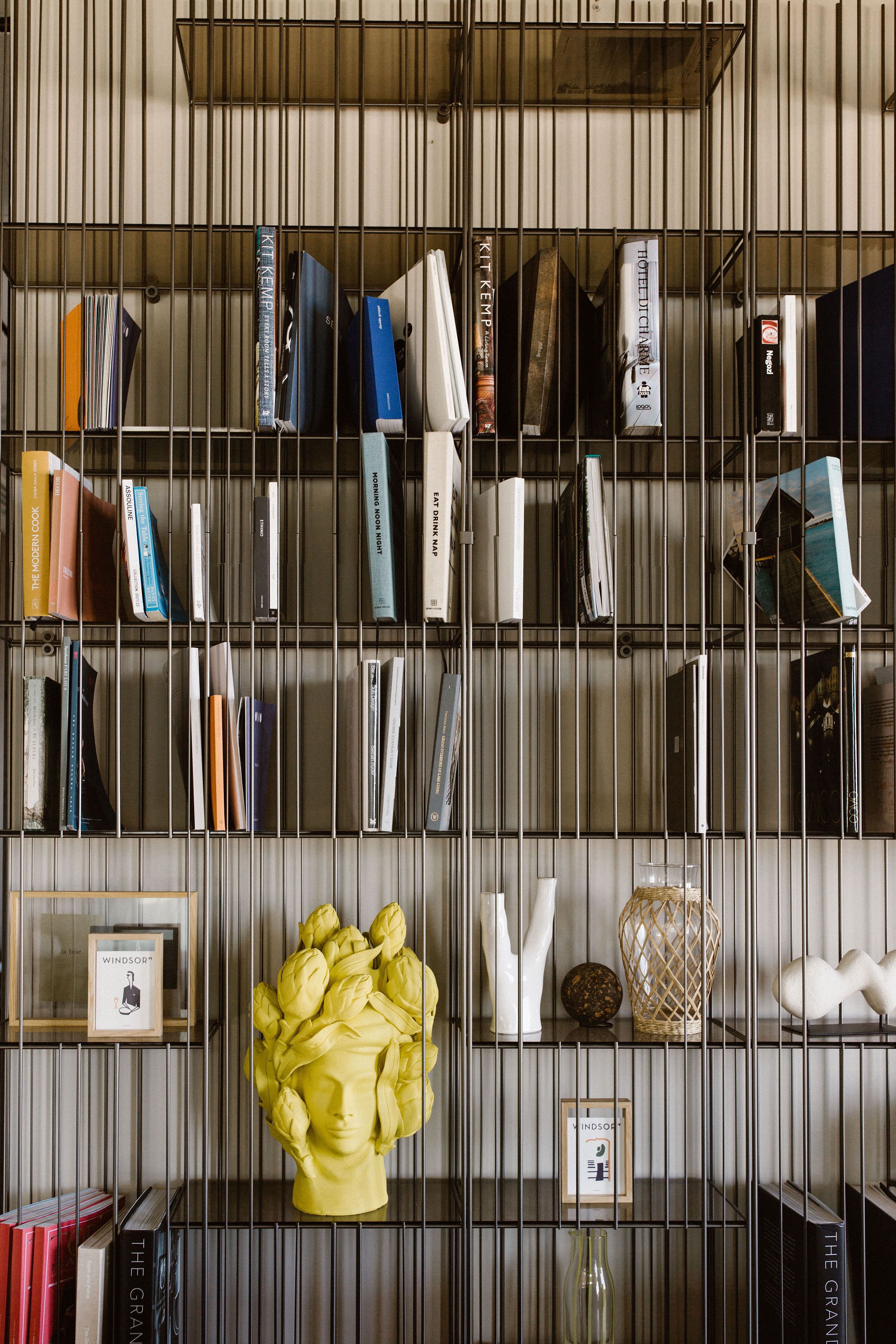 A bookshelf with various books and decorative items.