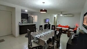 A compact living space with a kitchen, dining area, and a living room.