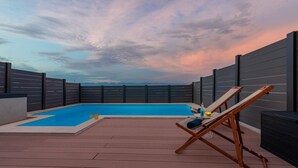 A rooftop pool area with a clear view of the sky and mountains in the background. - Villa NiA Zadarvillas (Nin)