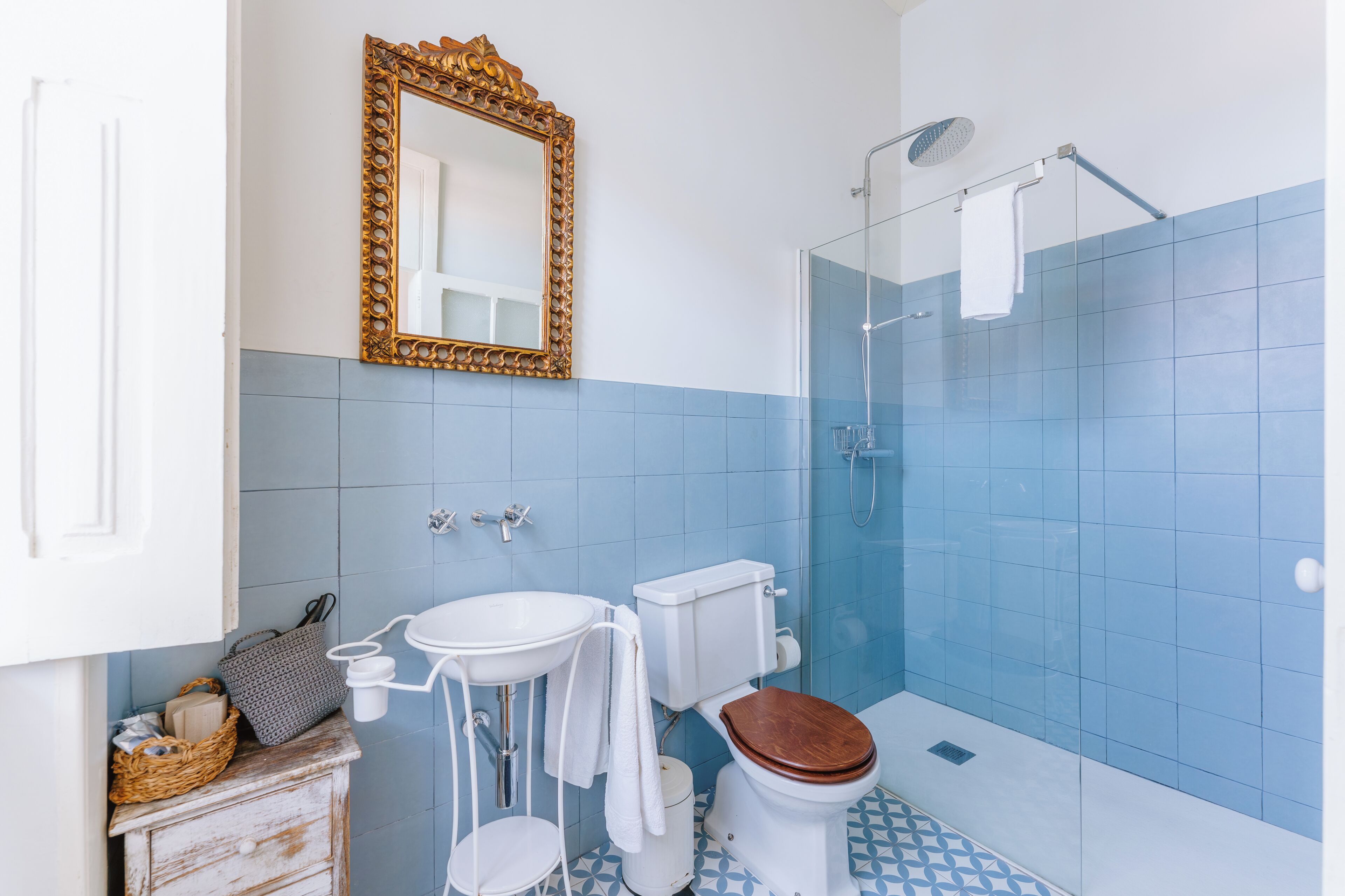 A bathroom with a toilet, sink, and shower.