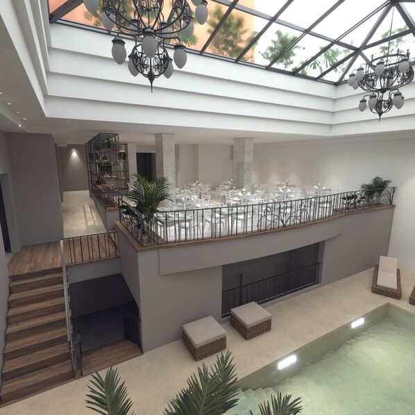 A spacious indoor area with a high ceiling, a balcony with tables and chairs, and a staircase. - Gardi Hotel & Suites (Buenos Aires)