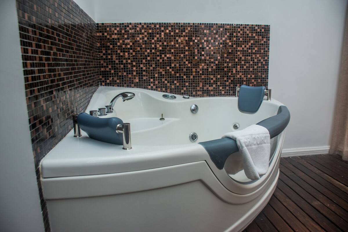 panoramic suite | bathroom | rainfall showerhead, designer toiletries, hair dryer, bathrobes