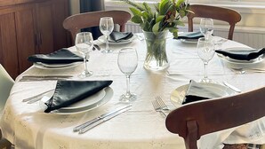 A dining table set with white tablecloth, black napkins, and clear glassware. - 3 bedroom accommodation in Anstruther (Anstruther)