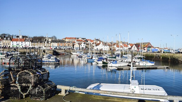 A harbor with boats docked, a pier, and buildings in the background. - 3 bedroom accommodation in Anstruther (Anstruther)
