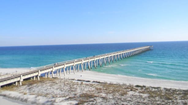 A pier extending into the ocean with a beach in the foreground. - Perfect Private Navarre Beach Getaway! 4 minute from the beach! (Navarre)