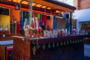 A bar with a wooden counter, potted cacti, and a sign that reads 'BAR'. - Hotel Giorgetti Palace (Bellaria)