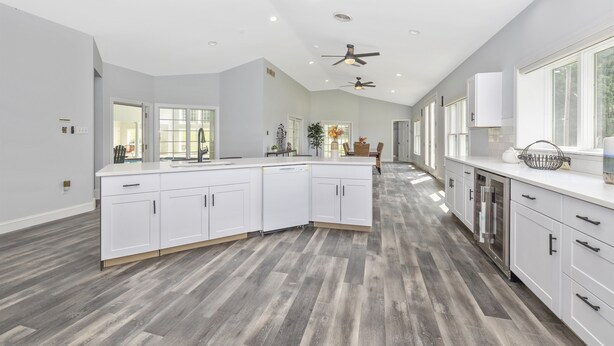 A spacious kitchen with white cabinetry, a central island, and a ceiling fan. - 4BR, 4BA, Amazing Indoor Pool, EV charger, ~10 acres retreat, next to Park (Big Pool)