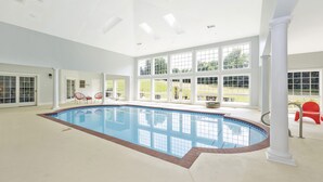 A large indoor swimming pool with a clear view of the outdoors through large windows. - 4BR, 4BA, Amazing Indoor Pool, EV charger, ~10 acres retreat, next to Park (Big Pool)
