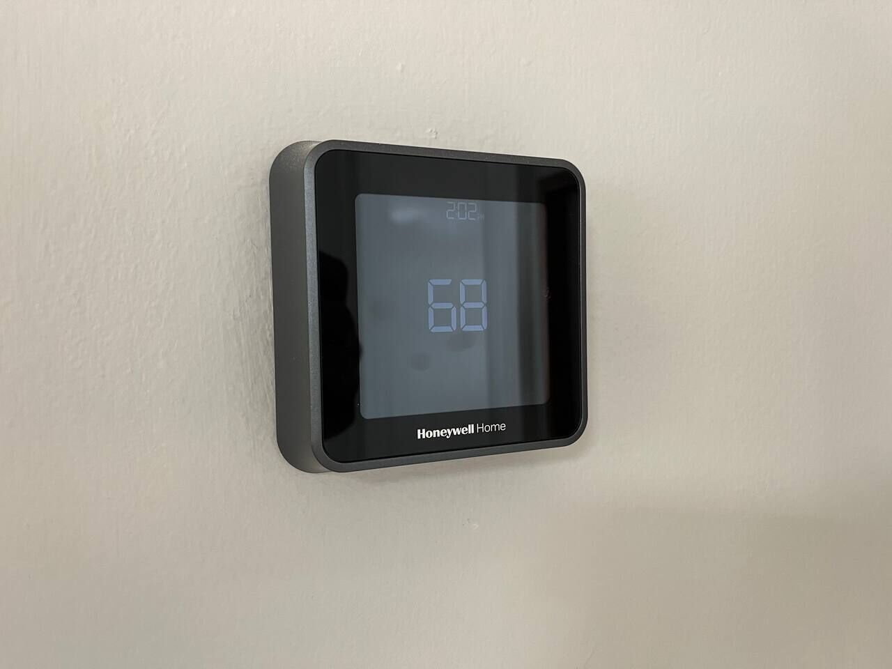 A Honeywell Home thermostat mounted on a wall.