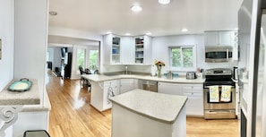 Enjoy cooking in this well-equipped kitchen with a central island, sink, and stainless steel oven.