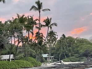 A tropical landscape with palm trees, a beach, and a small building. - Only non- resort beach neighborhood in Kohala Resort Area.Old Hawaii (Waimea)