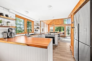 Enjoy cooking in this well-equipped kitchen with a central island, ample counter space, and large refrigerator.