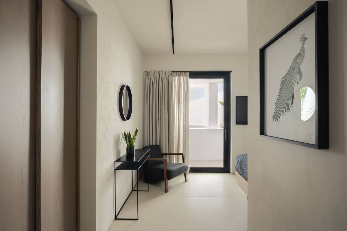 A modern interior with a desk, chair, and framed artwork.