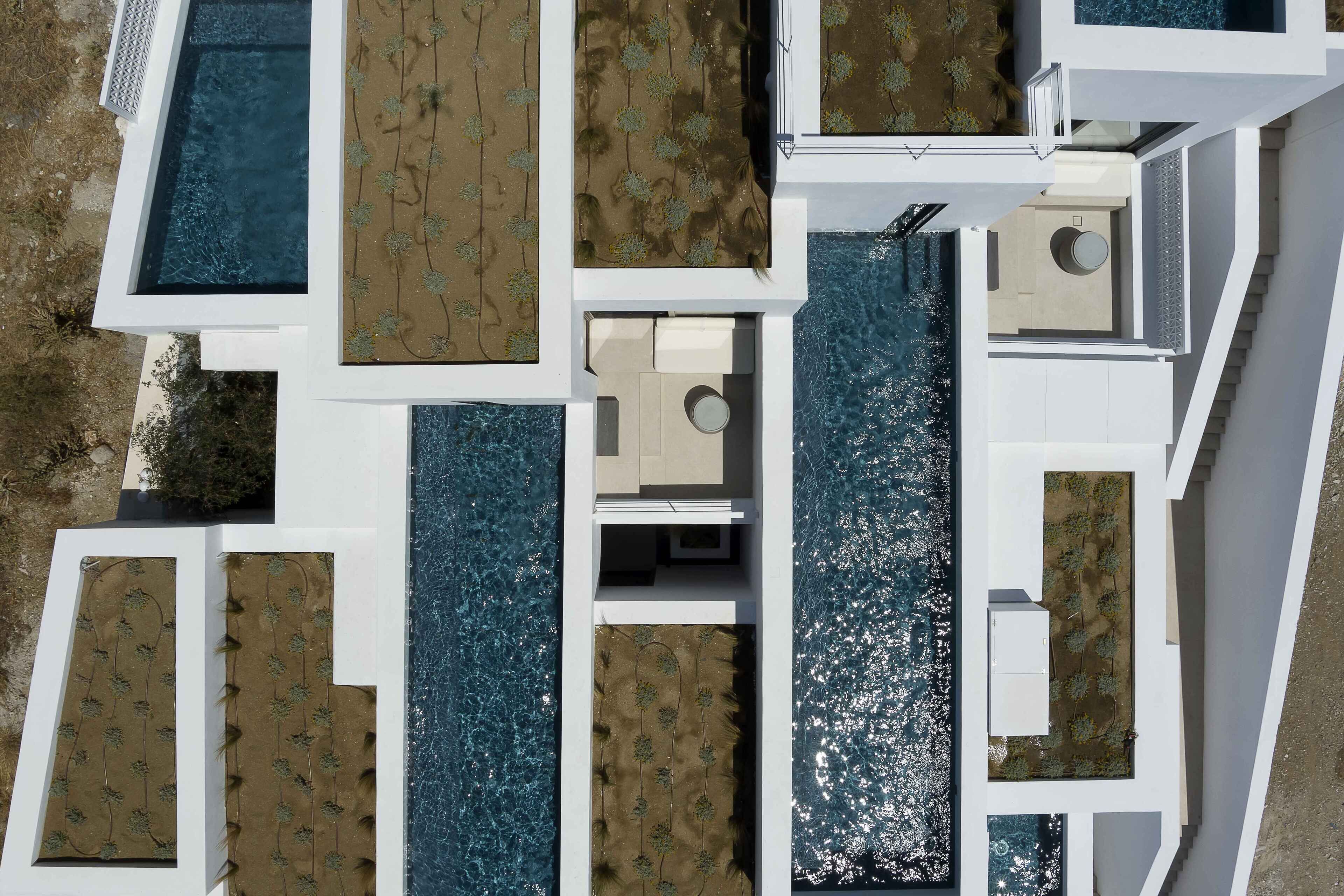 A modern building with a pool, multiple balconies, and a central courtyard.