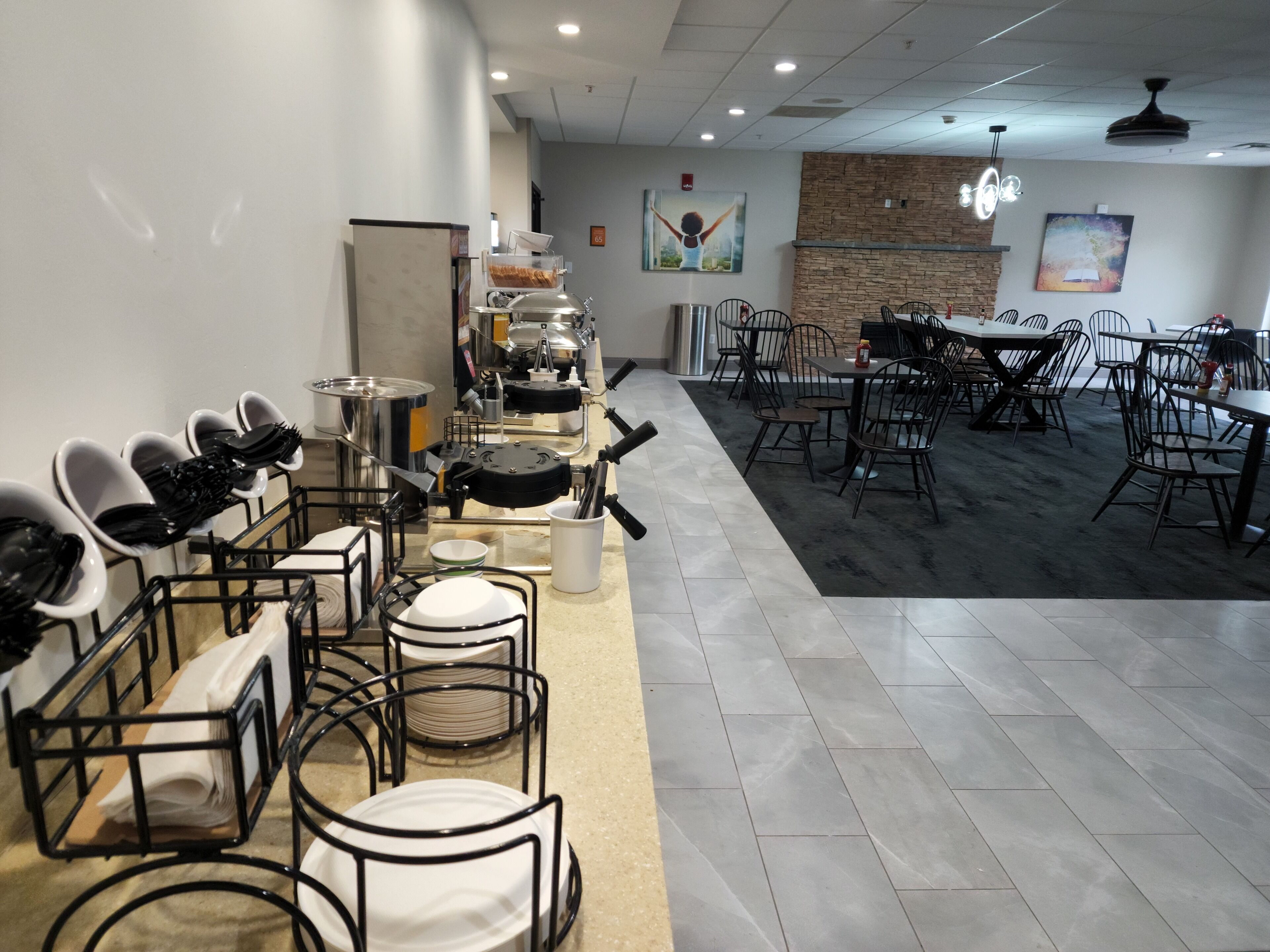 A restaurant with a buffet setup, including a food display and seating area.