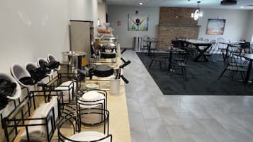 A restaurant with a buffet setup, including a food display and seating area.