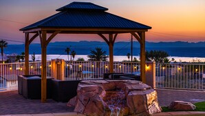 A gazebo with a metal roof, surrounded by a railing and seating area, overlooking a body of water and mountains. - Luxury Lake View Villa with  Pool, Spa, Sleeps 14, Boat parking (Lake Havasu City)