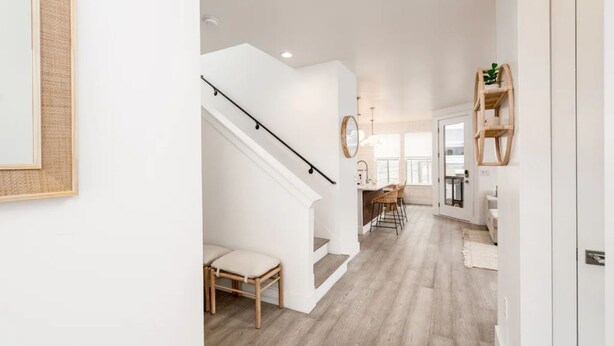 A spacious hallway with a staircase leading to a dining area. - Eastside Oasis *Walk to Bars, Brews & Good Eats* (Austin)
