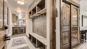A hallway with a bench, wooden cabinets, and a coat rack. - Ski-In Ski-Out, Skiwatch - Peak 8 Breckenridge, Sleeps 12  Newly Renovated (Breckenridge)