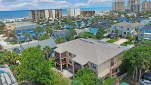 A residential area with multiple-story buildings, some with balconies, and a view of the ocean. - BEAUTIFUL & SPACIOUS 2BR/2BA BEACH CONDO (Jacksonville Beach)