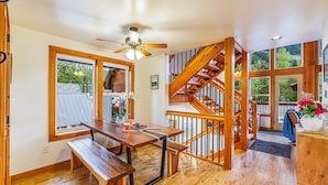 A wooden interior with a staircase, a dining table, and benches. - Feature: Skiing, Sledding, Snoqualmie Summit East (Snoqualmie Pass)